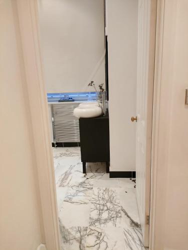a bathroom with a sink and a mirror at Versailles in Nottingham