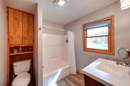 a bathroom with a toilet and a tub and a sink at Riverfront Fulton Vacation Rental with Deck and Grill! in Fulton