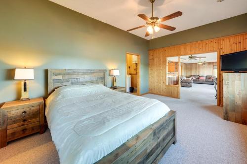 a bedroom with a large bed and a ceiling fan at Riverfront Fulton Vacation Rental with Deck and Grill! in Fulton