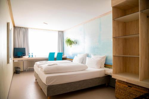 Postel nebo postele na pokoji v ubytování Abalon Hotel ideal