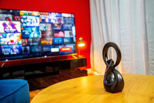 a pair of scissors sitting on a table in front of a television at Kent Tonbridge Townhouse in Kent