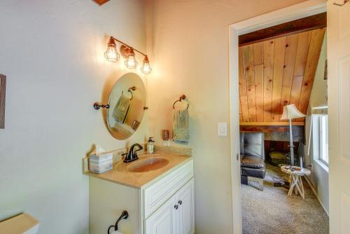 a bathroom with a sink and a mirror at Less Than 2 Mi to Dtwn Prescott Cabin with Furnished Deck in Prescott