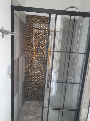 a door to a room with a wall with gold designs at Alaçatı Frida Hotel in Cesme