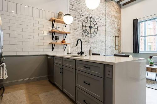 a kitchen with a sink and a counter at Gorgeous Condo in the Heart of DT Birmingham! in Birmingham