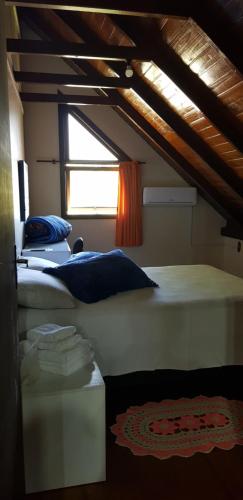 a room with two beds and a window at Chalé JS in São Bento do Sul