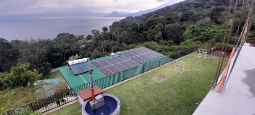 an aerial view of a house with a solar array on the roof at Refugio del Volcan Casitas in San Pedro La Laguna