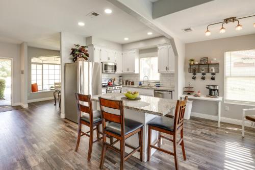 a kitchen with a table and chairs and a refrigerator at Pet-Friendly Family House with Pool and Backyard in Bakersfield