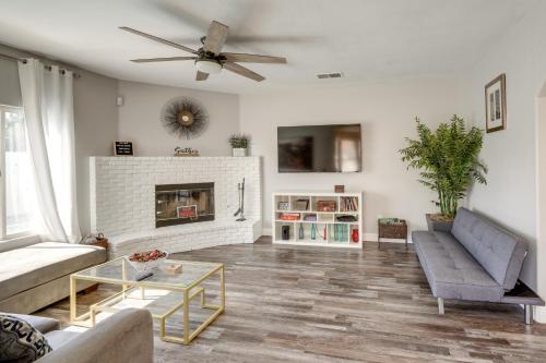 a living room with a couch and a fireplace at Private Pool and Patio Pet-Friendly Bakersfield Gem in Bakersfield
