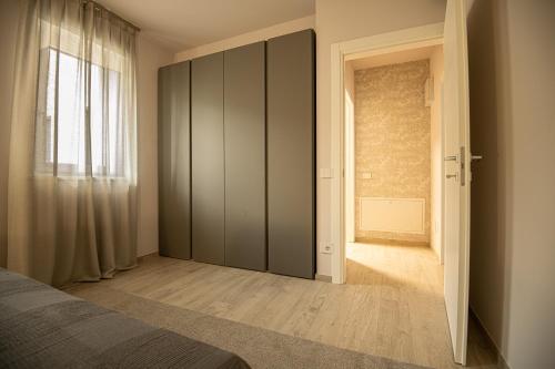 um quarto com um grande armário e uma porta em Alloggio moderno in centro paese em Corneliano d'Alba