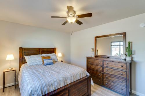 a bedroom with a bed and a dresser and a ceiling fan at Private Patio and Fire Pit at Gold Canyon Getaway! in Gold Canyon