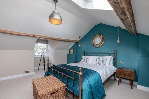 a bedroom with a bed with a blue wall at Abbey Lodge in Llandudno