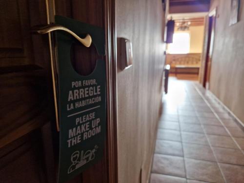 a sign on the door of a hotel room at Hostal La Plata in Oropesa