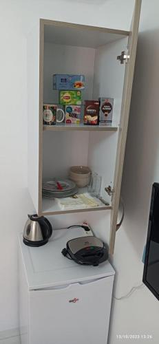 a white refrigerator with a counter in a kitchen at HELEN's ROOM in Artemida