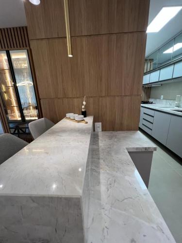 a large kitchen with a large marble counter top at Canela Cantinho dos Sonhos in Canela