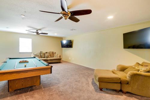 a living room with a pool table and a ceiling fan at Expansive Texas City Retreat about 16 Mi to Galveston! in Texas City