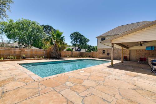 a swimming pool in a yard with a house at Expansive Texas City Retreat about 16 Mi to Galveston! in Texas City