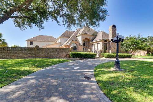 a house with a street light in front of a driveway at Expansive Texas City Retreat about 16 Mi to Galveston! in Texas City