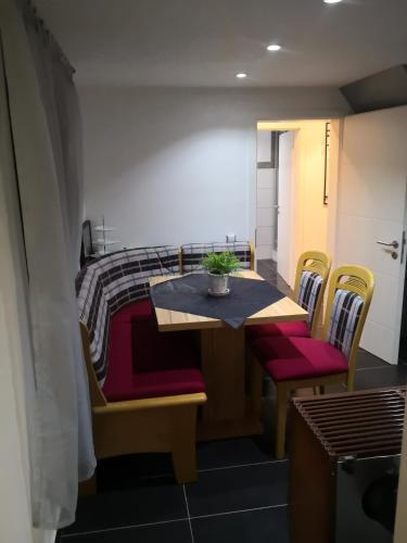 a room with a table and chairs and a bed at Haus am Fluss in Urft