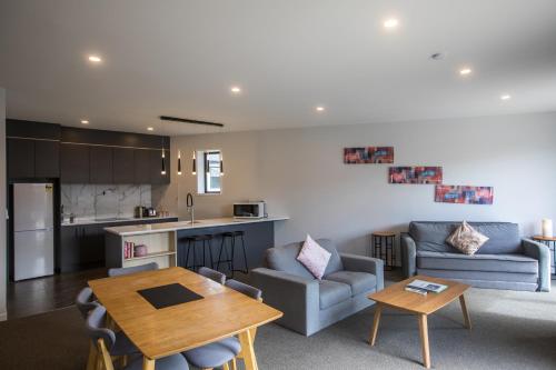 a kitchen and living room with a table and a couch at Skyblue Tekapo in Lake Tekapo