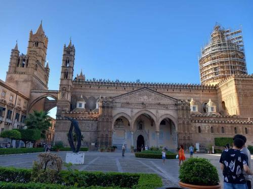 a large stone building with two towers on top at PAIPER B&B in Palermo