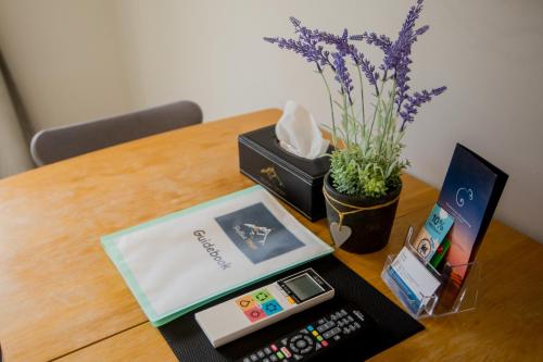 a table with a remote control and a box on it at Skyblue Tekapo in Lake Tekapo