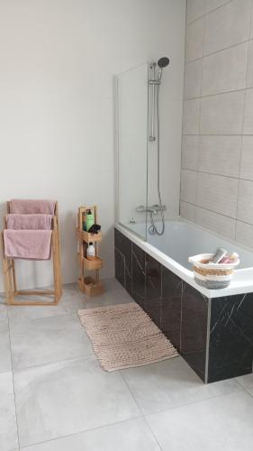 a bathroom with a bath tub and a sink at Maison au calme in Livry-Gargan