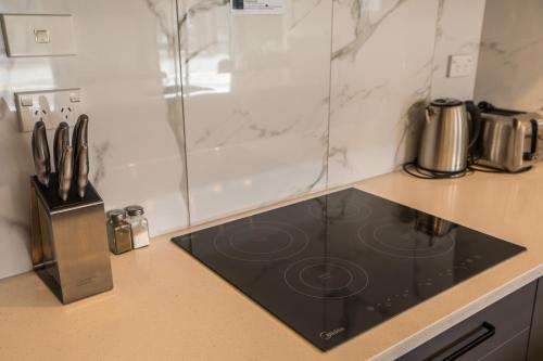 a kitchen counter with a black stove top oven at Skyblue Tekapo in Lake Tekapo