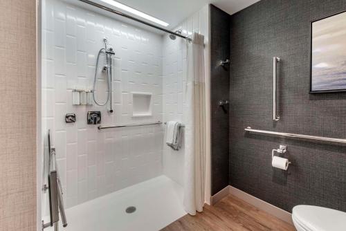 a bathroom with a shower and a toilet at Cambria Hotel Minneapolis Downtown in Minneapolis
