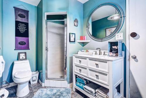 a bathroom with a toilet and a sink and a mirror at The Malibu Retreat Guest House - Salt Water Pool & Jacuzzi, Nature Oasis in Calabasas