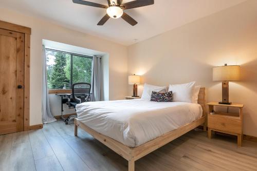 a bedroom with a bed with a ceiling fan and a desk at One BDR in the Heart of Olympic Valley in Alpine Meadows