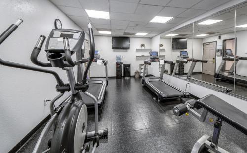 a gym with several treadmills and machines at Country Inn & Suites by Radisson, Ontario at Ontario Mills, CA in Ontario