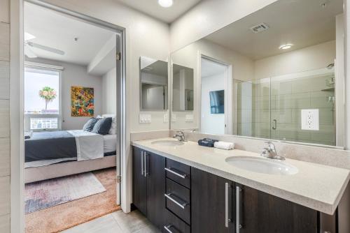 a bathroom with a sink and a bedroom with a bed at Brand New 2BR WeHo Luxury Apartment in Los Angeles