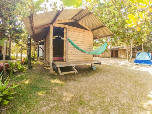 a shed with a hammock and a tent at Camping Atobá Praia do Sono in Paraty