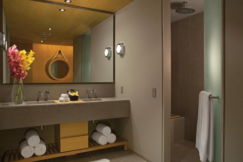 a bathroom with a sink and a mirror at Breathless Cabo San Lucas - Adults Only in Cabo San Lucas