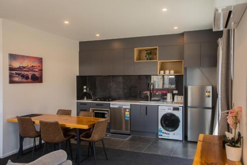 a kitchen with a wooden table and a dining room at Skyrim Lodge in Lake Tekapo