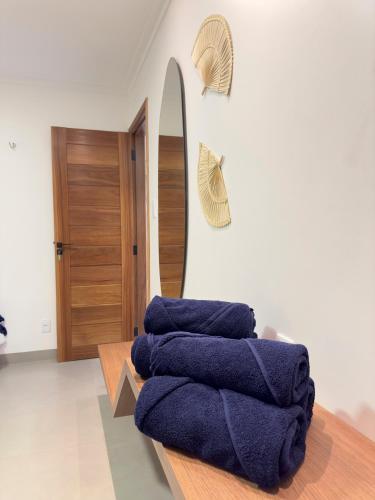 a room with blue towels on a table and a mirror at Alter do Chão - Alter Casa Cocar in Alter do Chao