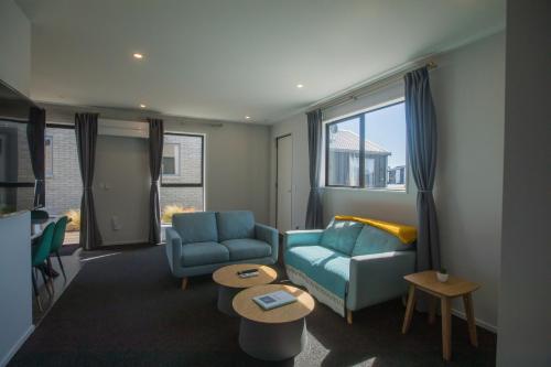 a living room with two chairs and a couch and a table at Skyrim Lodge in Lake Tekapo