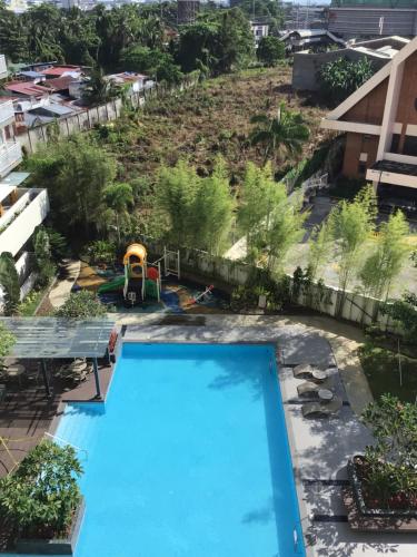 an overhead view of a swimming pool with a playground at Balcony View Studio Mesatierra Garden Residences in Davao City