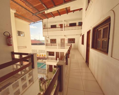 a hallway of a building with a view of a pool at Hotel 5 Sóis in Olinda