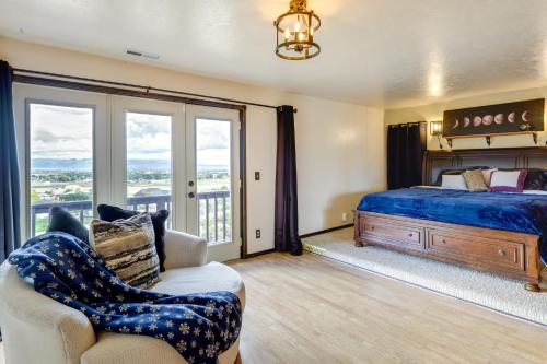 um quarto com uma cama, uma cadeira e uma janela em Airy Vernal Vacation Rental Deck, Mountain Views! em Vernal