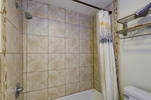 a shower in a bathroom with a shower curtain at Vernal Home - 19 Mi to Dinosaur National Monument! in Vernal