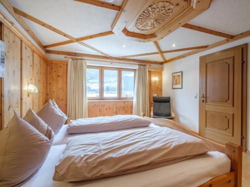 a bedroom with a large bed and a window at Kitzbüheler Alpen XL in Bramberg am Wildkogel