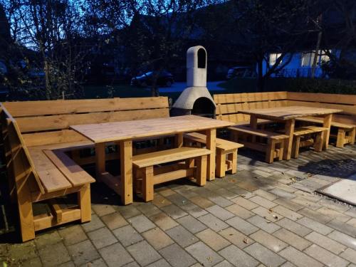 a group of wooden benches and tables on a patio at Kitzbüheler Alpen XL in Bramberg am Wildkogel