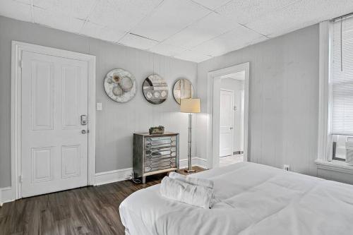 a white bedroom with a white bed and a window at Midtown 1BR: Downtown HBG Hub in Harrisburg