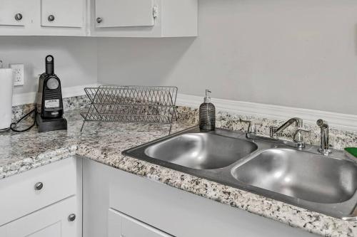 a kitchen counter with a stainless steel sink at Midtown 1BR: Downtown HBG Hub in Harrisburg