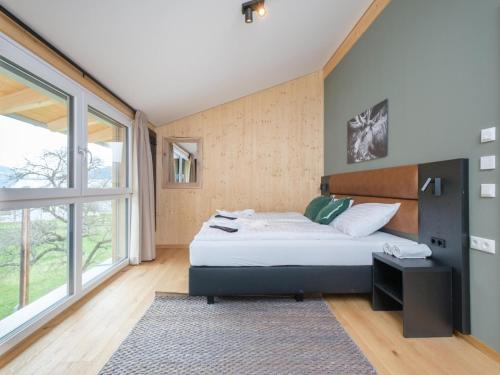a bedroom with a bed and a large window at Aquarius Haus 9 TOP 18 in Sankt Lorenzen ob Murau