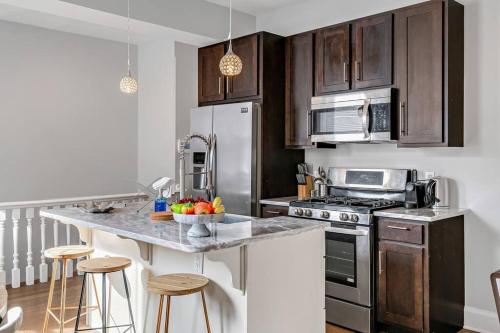 a kitchen with wooden cabinets and a counter top at Charming HBG Haven: Cozy 1BR Apt in Harrisburg