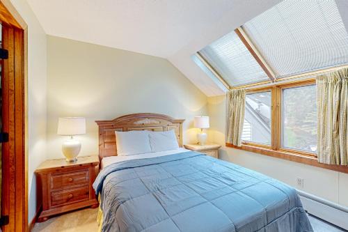 a bedroom with a bed and two lamps and a window at Sunrise: West Glade-G4 in Killington