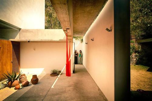 a hallway of a house with potted plants at Casa Meztitla in Tepoztlán