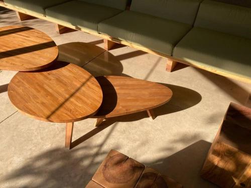 an overhead view of two wooden tables and a couch at Casa Meztitla in Tepoztlán